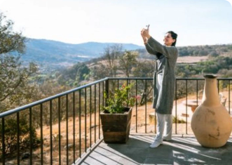 Woman taking a selfie on her smartphone in a vacation home