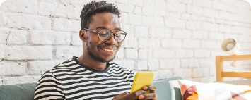 Young African Man Working From His Smartphone