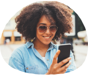 girl smiling and looking at her mobile device