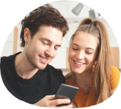 happy couple looking at a mobile device