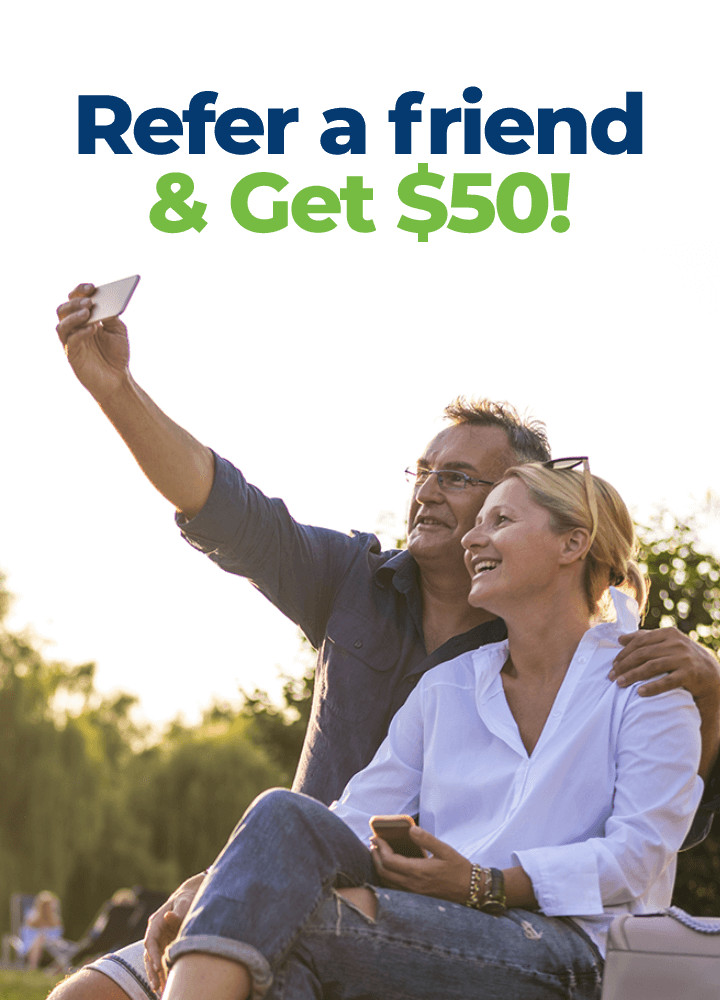 Older couple taking a selfie. Text says Refer a friend and get $50!