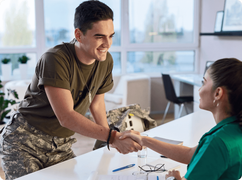 Soldier shaking hands with woman