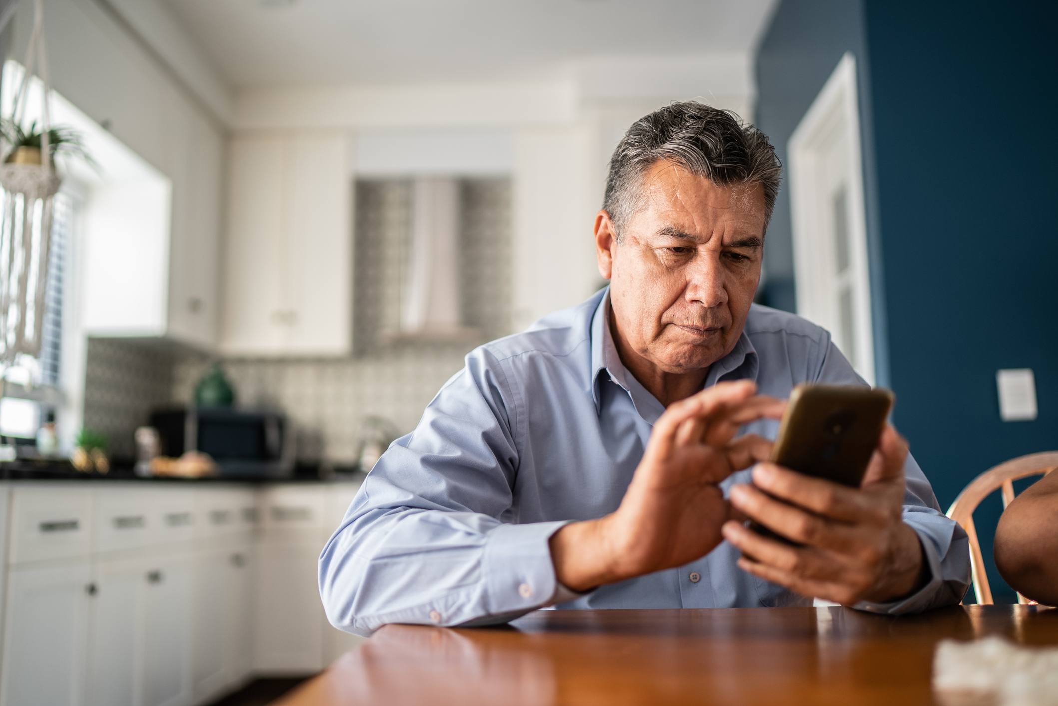 Older man looking at his phone