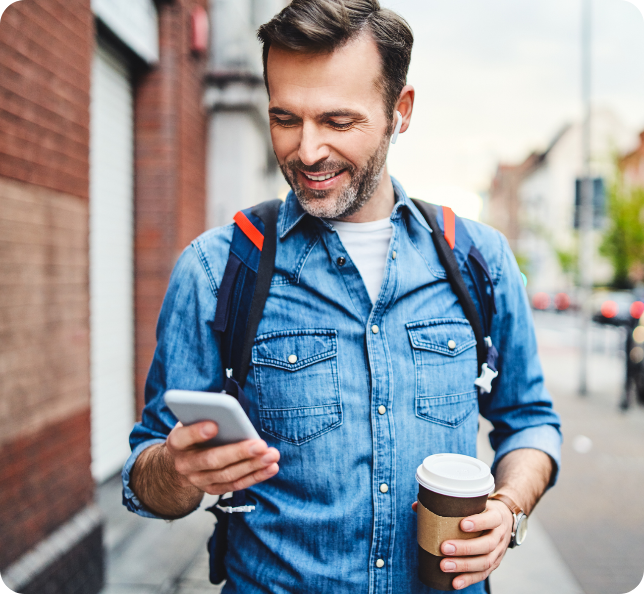 Middle age man on international backpacking trip checking cell phone