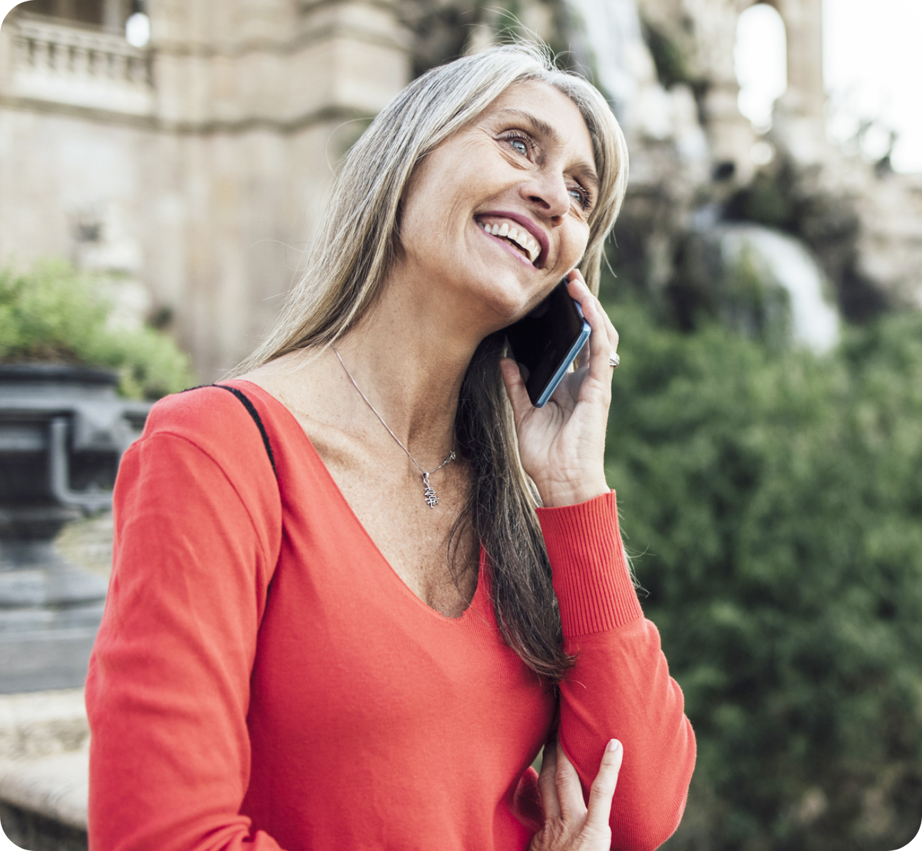 Woman in front of historic monuments making international call